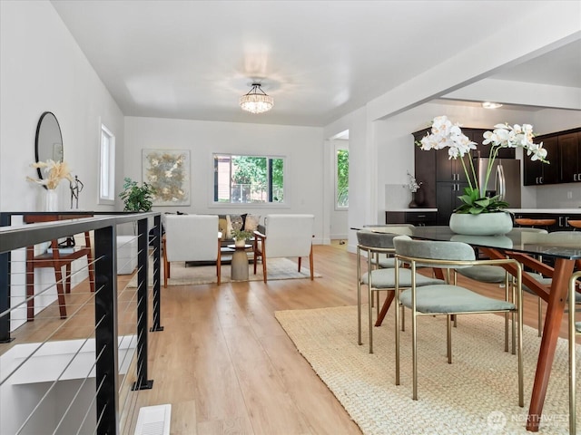 dining area featuring a chandelier and light wood-style flooring