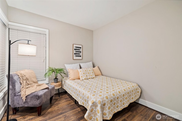 bedroom with wood finished floors and baseboards