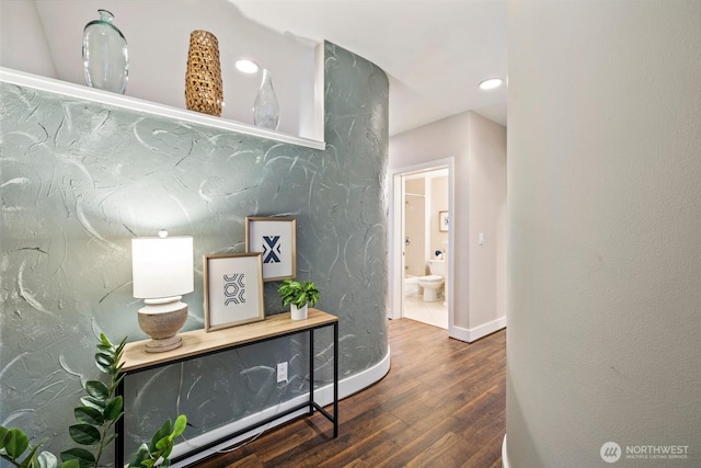 corridor featuring recessed lighting, baseboards, and wood finished floors