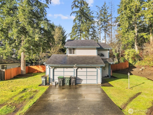 traditional-style home featuring concrete driveway, a front yard, and fence