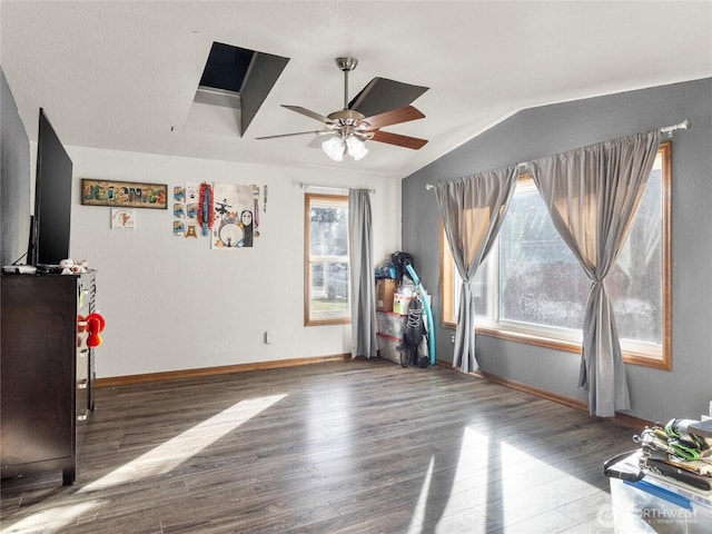 bedroom with ceiling fan, vaulted ceiling, baseboards, and wood finished floors