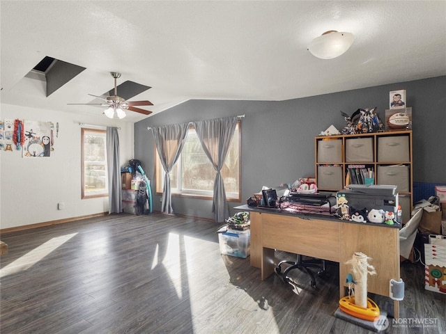 office area with dark wood-style floors, vaulted ceiling, a ceiling fan, and baseboards