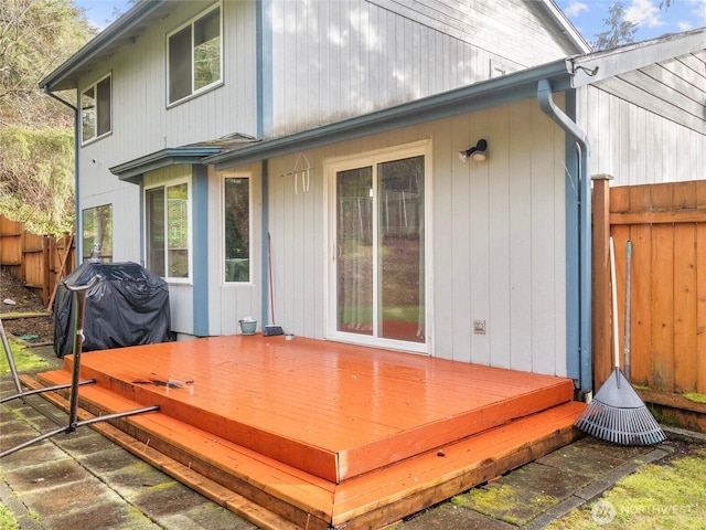 wooden terrace featuring fence and area for grilling