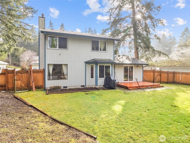 back of property featuring a gate, a fenced backyard, a chimney, and a wooden deck