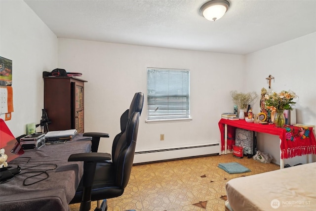 office featuring baseboard heating, a textured ceiling, and tile patterned floors