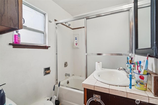 bathroom with shower / bath combination with glass door, vanity, and toilet