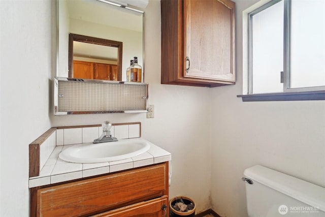 half bath featuring toilet and vanity