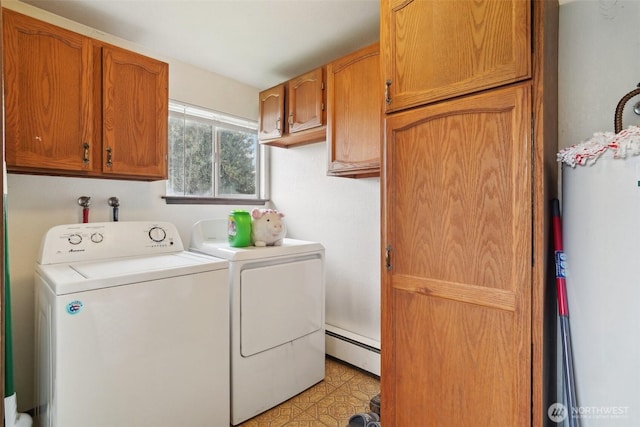 laundry area featuring cabinet space, baseboard heating, light floors, and washing machine and clothes dryer