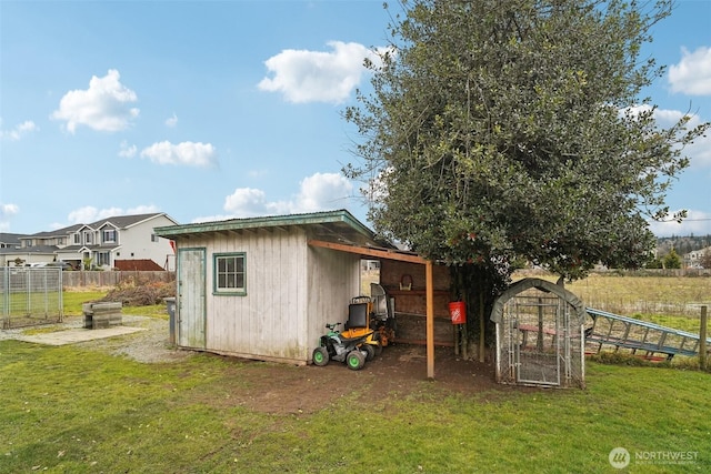 view of outbuilding featuring an outdoor structure and fence