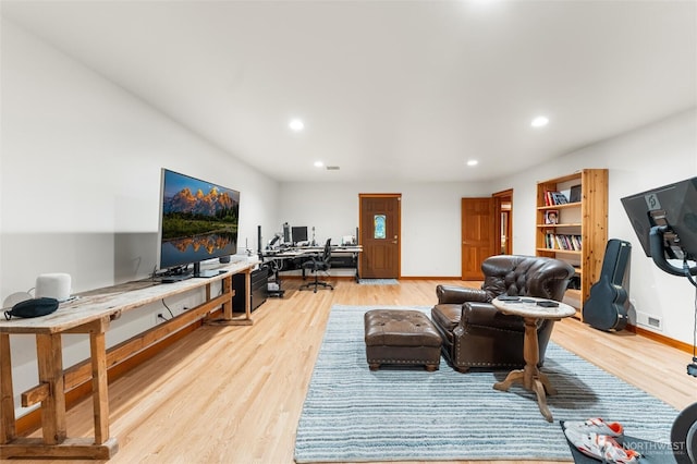 living area featuring baseboards, light wood-style flooring, and recessed lighting