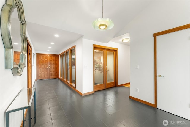 corridor featuring recessed lighting, french doors, vaulted ceiling, and baseboards