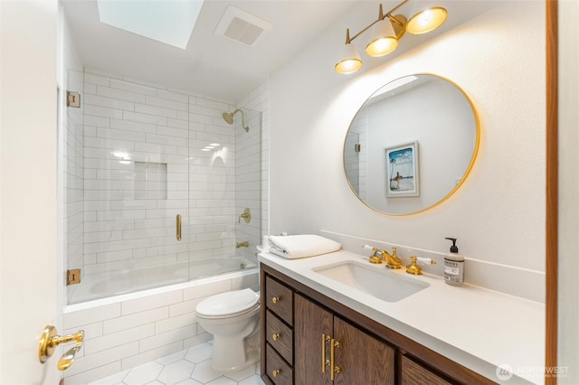 full bathroom featuring tiled shower / bath, visible vents, toilet, vanity, and tile patterned flooring