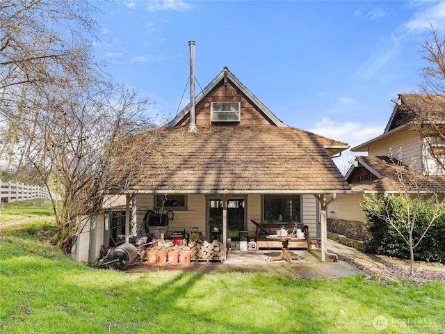 back of house featuring a patio area, fence, and a lawn