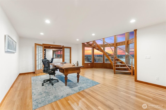 home office featuring recessed lighting, light wood-style flooring, baseboards, and french doors