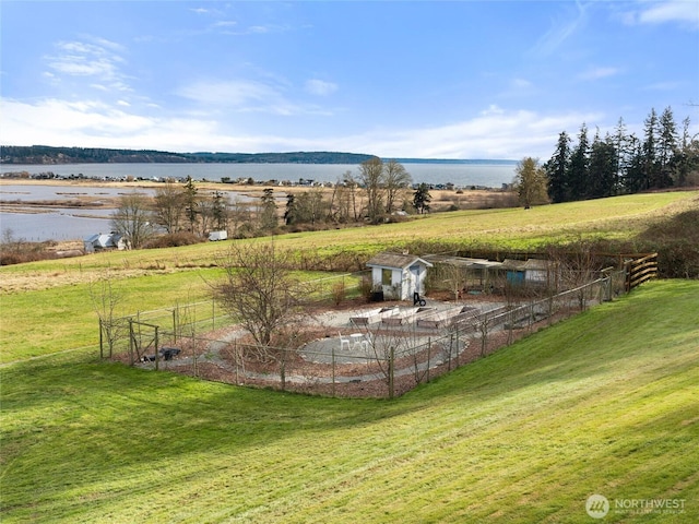 view of yard with a water view and a rural view