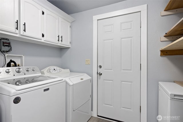 washroom with cabinet space and washing machine and clothes dryer