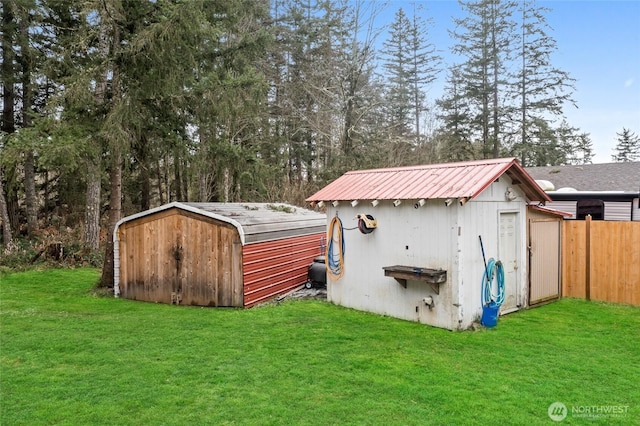 view of shed featuring fence