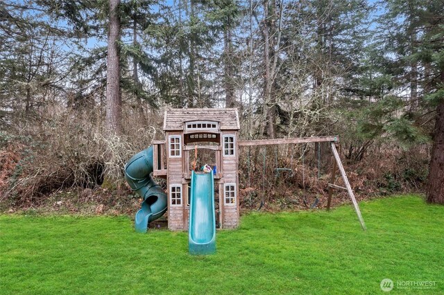 view of jungle gym featuring a lawn