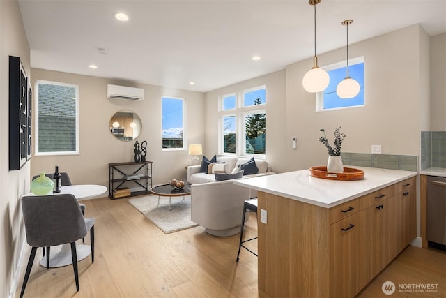 kitchen with a wall unit AC, light wood-style floors, a peninsula, and a breakfast bar