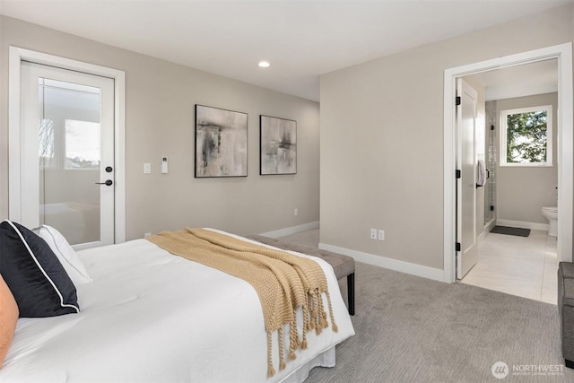 bedroom with recessed lighting, baseboards, ensuite bathroom, and light colored carpet