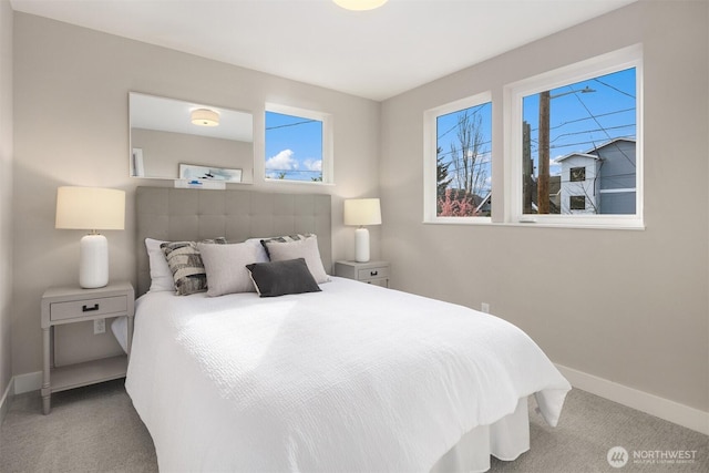 bedroom with carpet and baseboards