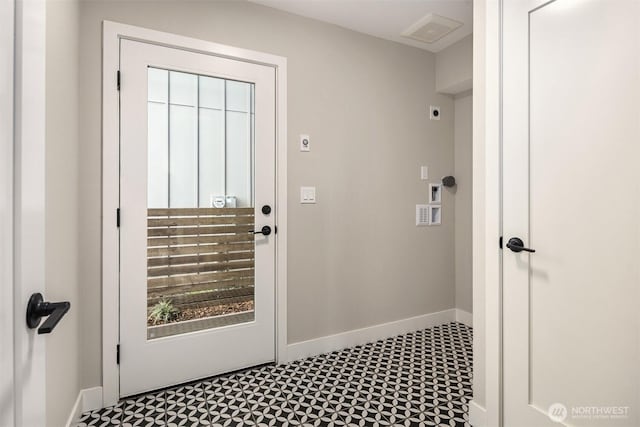 entryway with baseboards and tile patterned floors