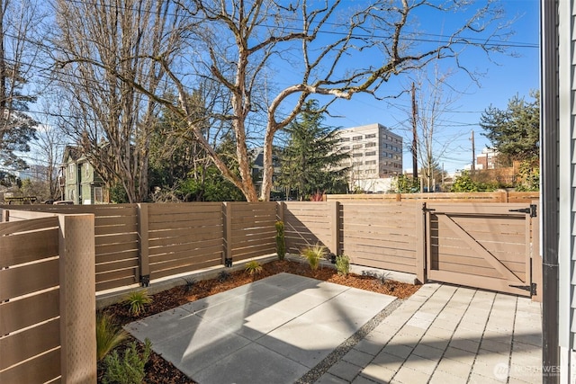 view of patio with a gate and fence