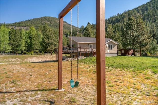17353 Jenne Dr, Entiat, WA 98822 - view of yard with a view of trees, a deck with mountain view, and fence