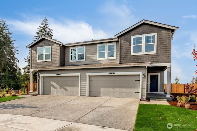 view of front of house with a garage, driveway, a front yard, and fence