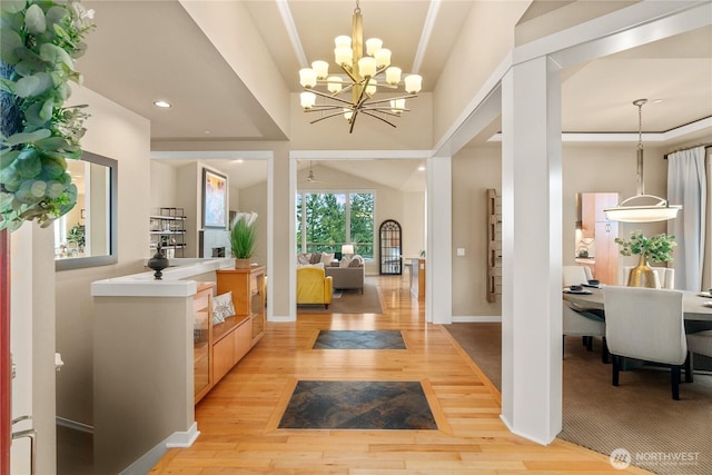 foyer featuring recessed lighting, baseboards, an inviting chandelier, and light wood-style flooring