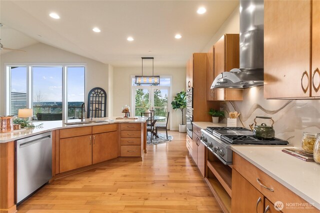 kitchen with a sink, stainless steel appliances, light countertops, and island range hood