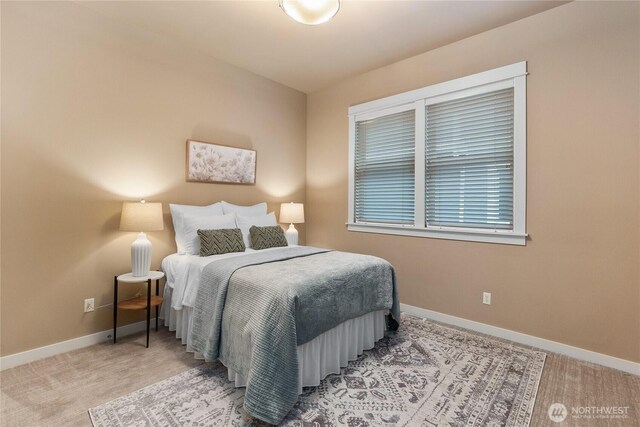 bedroom with carpet flooring and baseboards