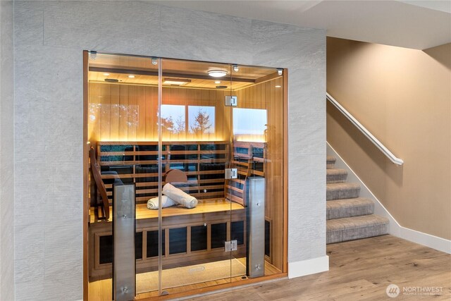 view of sauna / steam room featuring baseboards and wood finished floors