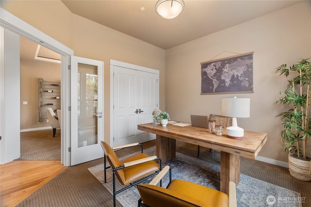 office area with french doors, baseboards, and wood finished floors