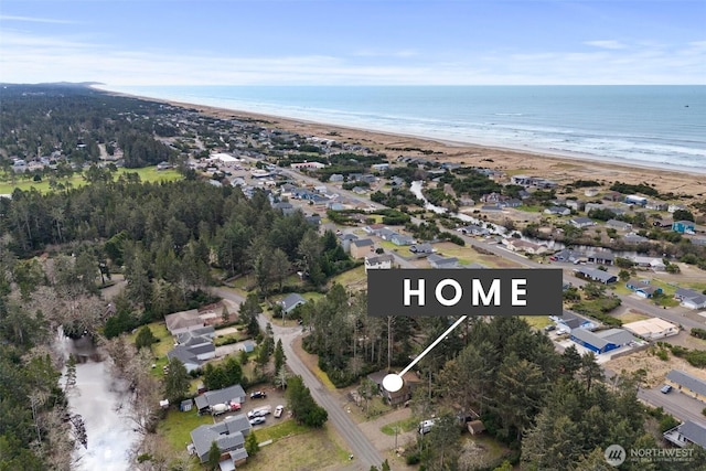 bird's eye view featuring a water view and a beach view