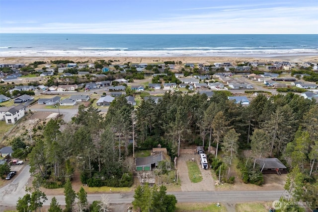 drone / aerial view featuring a water view and a beach view