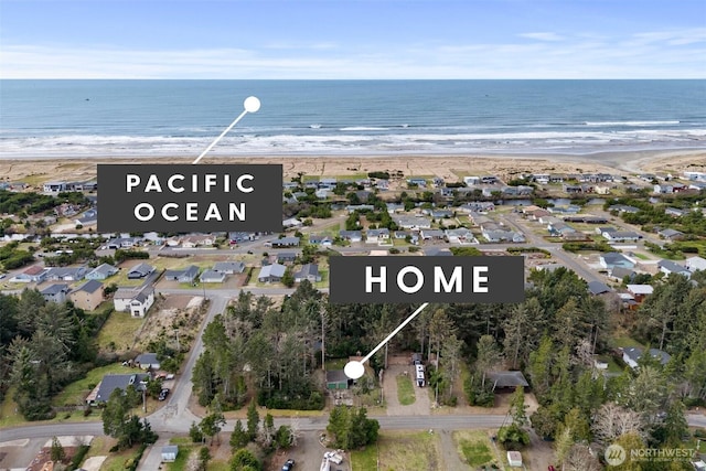 aerial view with a water view and a beach view