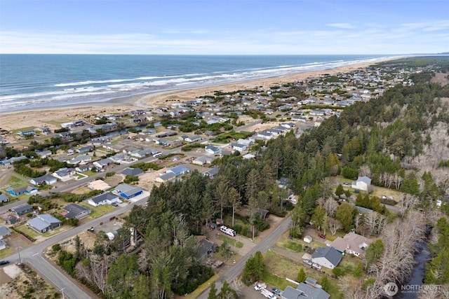 bird's eye view featuring a water view and a beach view