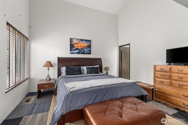 bedroom featuring visible vents and high vaulted ceiling