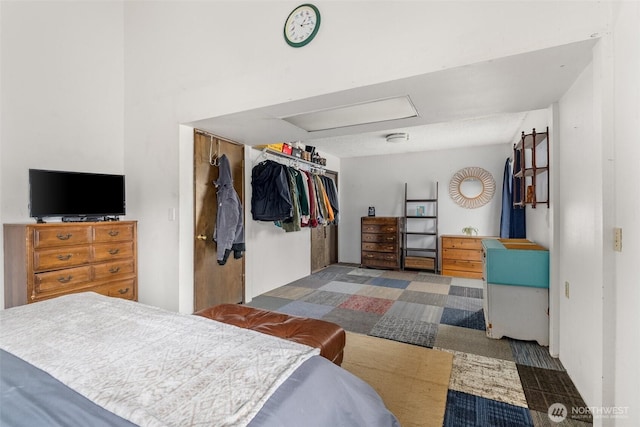 bedroom with attic access and a closet