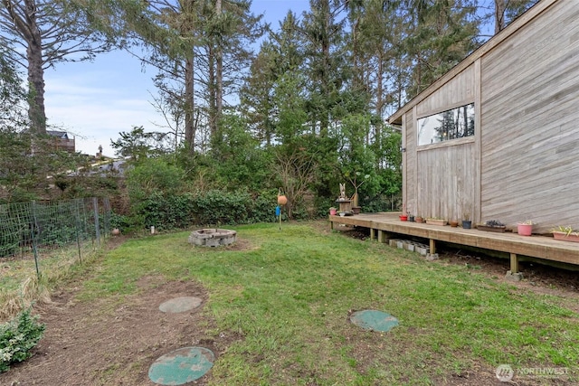 view of yard with a fire pit and fence