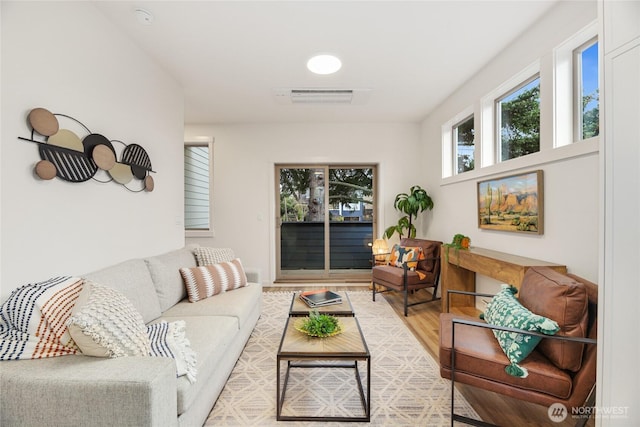 living area with wood finished floors and visible vents