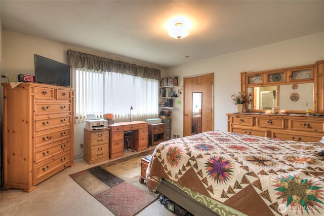 bedroom featuring light carpet