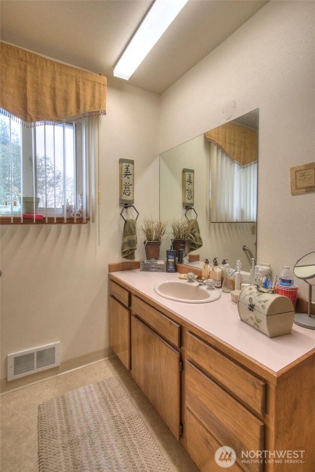 bathroom with visible vents and vanity