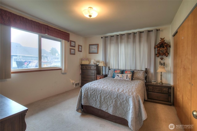 bedroom featuring carpet floors and visible vents