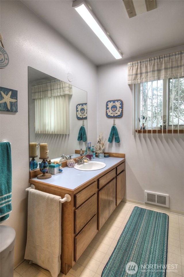 bathroom featuring tile patterned flooring, visible vents, and vanity