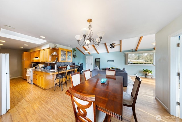 dining space with vaulted ceiling with skylight, baseboards, light wood-type flooring, a notable chandelier, and recessed lighting