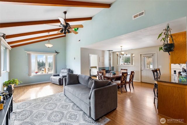 living room with high vaulted ceiling, ceiling fan with notable chandelier, wood finished floors, visible vents, and beam ceiling