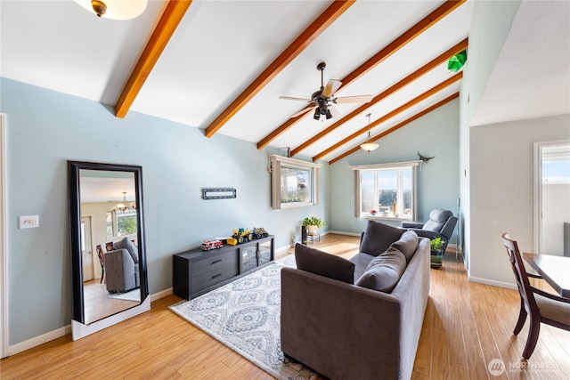 living area with light wood finished floors, baseboards, beamed ceiling, high vaulted ceiling, and ceiling fan with notable chandelier