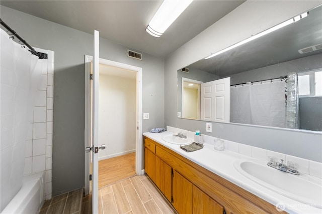 full bathroom featuring a sink, visible vents, and wood tiled floor